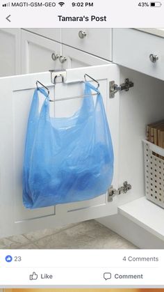 a blue bag hanging from the side of a cabinet