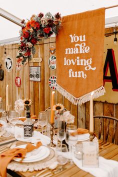 a table set up for a party with an orange banner