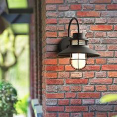 an outdoor light on the side of a brick building