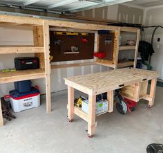 two workbenches in a garage with tools on the shelves