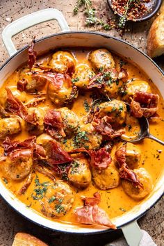 a pan filled with chicken and potatoes covered in gravy