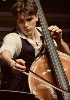 a young man is playing the cello