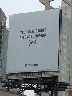 an advertisement is displayed on the side of a large building in front of tall buildings