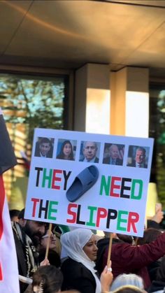 a group of people holding signs and flags