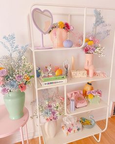 a white shelf filled with lots of different types of flowers