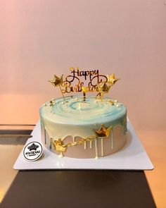 a birthday cake decorated with gold stars and the words happy birthday