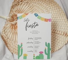 a close up of a menu on a table near a wicker basket with a straw hat