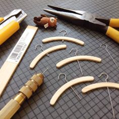 several pairs of wooden clothes hangers, scissors and other crafting tools on a table