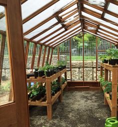 an indoor greenhouse with several plants in it