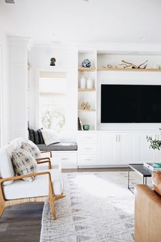 a living room filled with furniture and a flat screen tv