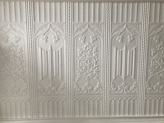 a white ceiling with decorative designs on it