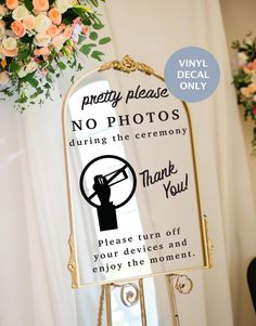 a sign that says no photos during the ceremony please turn off your devices and enjoy the moment