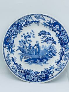 a blue and white plate with people on it