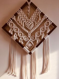 a wall hanging with tassels on it