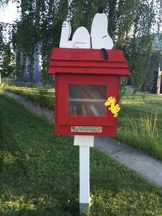 a red mailbox with snoopy the dog painted on it