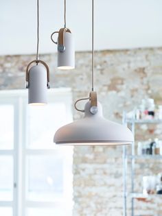 three lights hanging from the ceiling in a room