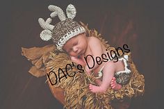 a baby wearing a knitted deer hat and diaper