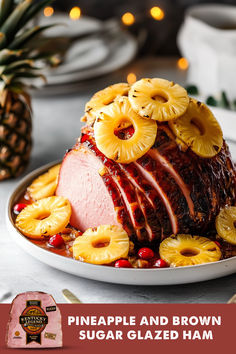 pineapple and brown sugar glazed ham on a platter with sliced pineapples