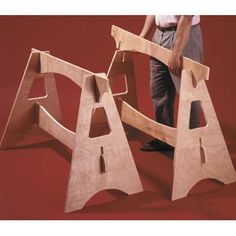 a man standing next to two wooden steps that are made out of plywood planks