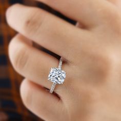 a woman's hand with a diamond ring on it