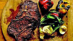 steak and vegetables on a wooden cutting board