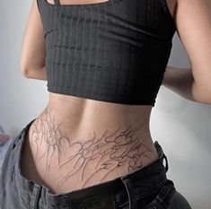 a woman with tattoos on her lower back