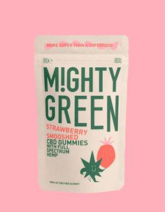 mighty green strawberry gummies on a pink background