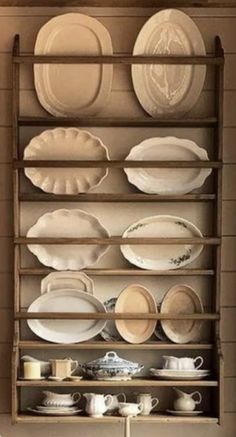 a shelf filled with white plates and dishes