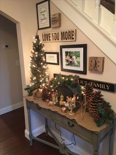 a christmas scene with pine cones and other holiday decorations on a table under the stairs