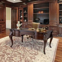 an elegant office with wood paneling and built - in bookcases is pictured