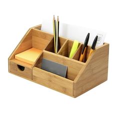 a wooden desk organizer with pens, papers and pencils