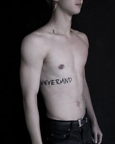 a shirtless man with the word never mind written on his chest and handwritten in black ink