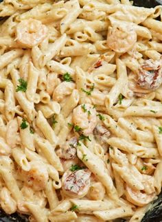 a skillet filled with pasta and shrimp