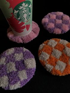 four coasters made to look like they have different colors and designs on them, including one with a starbucks logo