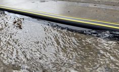 the street is flooded with water and rain