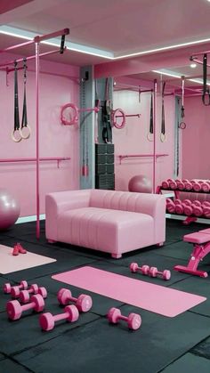 a pink gym room with exercise mats, dumbbells and yoga balls on the floor