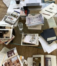 many books and magazines are spread out on the floor