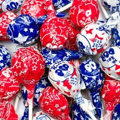 many red, white and blue lollipops are stacked on top of each other