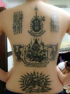 the back of a woman with tattoos on her body