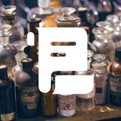 an assortment of bottles and jars on a table with the word f spelled in white