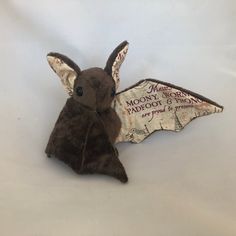 a stuffed animal bat sitting on top of a white table