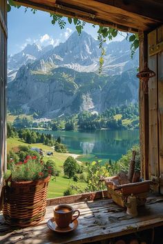 a table with a coffee cup on it in front of a window overlooking a mountain lake