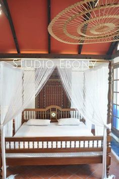 a bed sitting under a canopy in a bedroom