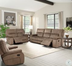 a living room with two recliners and a couch in it's center