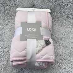 the ugg blanket is brand new and still in its box it's pink with white trim