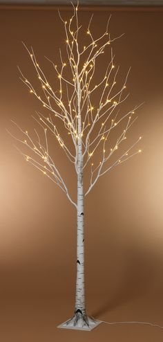 the white lighted tree is on display in front of a brown background with text that reads 6