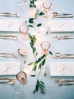 the table is set with silverware and place settings for an elegant dinner or reception