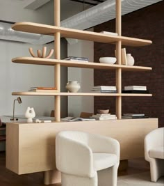 a room with some shelves and chairs in it