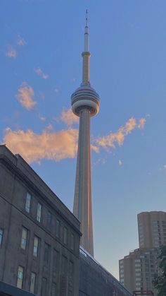 a tall building with a very tall tower next to it's top in the city