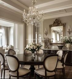 an elegant dining room with chandelier and chairs